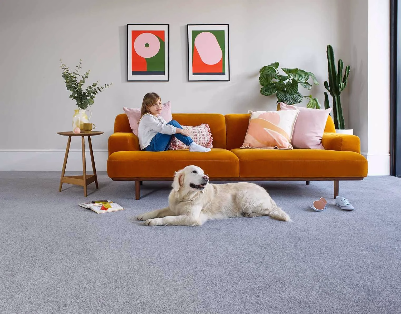 Child and dog on grey carpet in a family living room