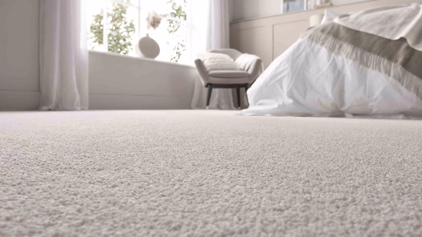 Pale carpet in a softly lit bedroom