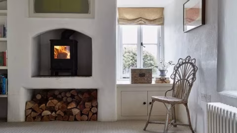 Light woven natural flooring in a cottage living room with a wood-burning stove