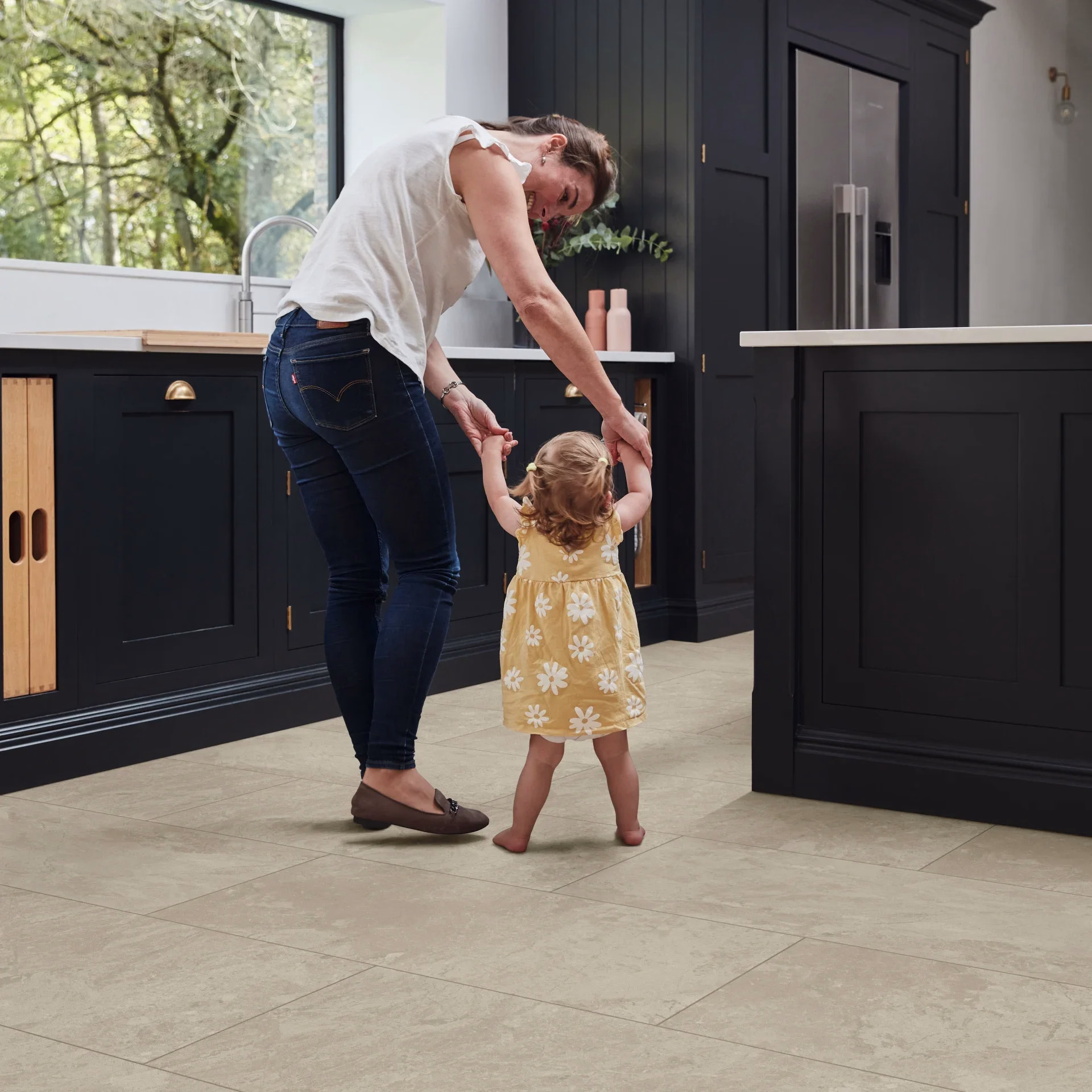 Mother and child standing on stone-effect vinyl flooring in a kitchen