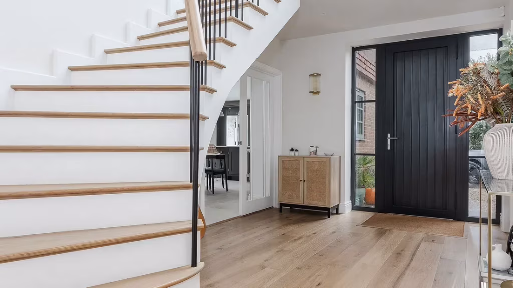Engineered oak flooring in a bright hallway with a curved staircase